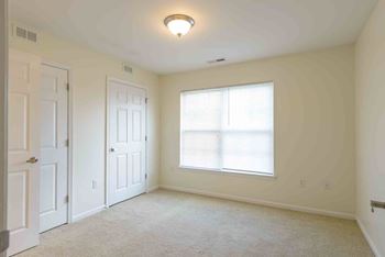 A room with a window and a carpeted floor. at Robinson Park Apartments, Harrisonburg